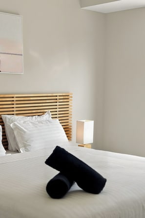 A hotel room with a bed, pillows, a bedside lamp, and a wall-mounted artwork. - Modern Getaway in Dunsborough (Dunsborough)