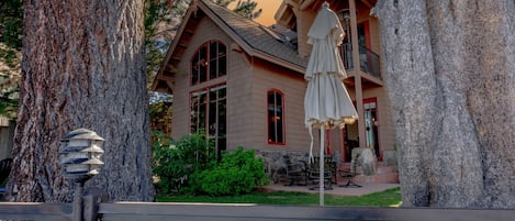 A lodge with a large wooden structure, a covered patio, and a stone lantern.