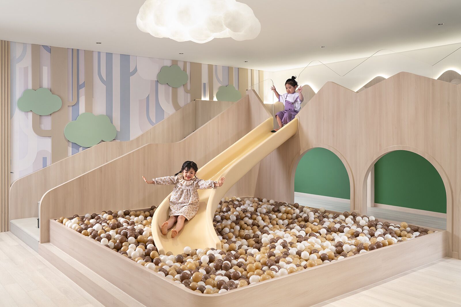 A children's play area with a slide and ball pit.