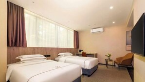 A hotel room with two beds, a desk, a chair, and an air conditioning unit. - Hotel Z (Shenzhen Futian Nonglin Subway Station) (Shenzhen)