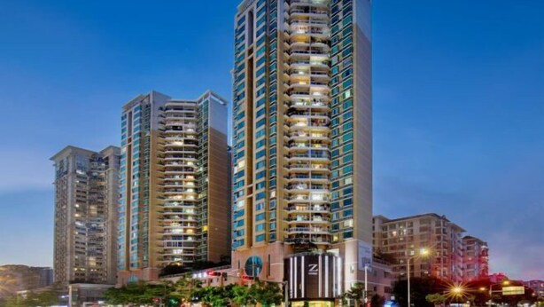 A high-rise hotel with multiple balconies, a prominent 'Z' logo, and a well-lit facade. - Hotel Z (Shenzhen Futian Nonglin Subway Station) (Shenzhen)