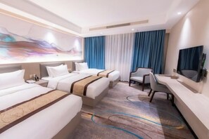 A hotel room with two beds, a desk, a chair, a TV, and a large abstract painting on the wall. - Longfeng Hotel (Enping)