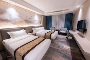 A hotel room with two beds, a desk, a chair, a TV, and a large mural on the wall. - Longfeng Hotel (Enping)