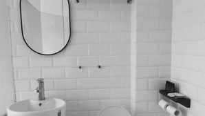 A bathroom with a white sink, a mirror, a toilet, and a towel rack. - XUQIANFENG (Shenzhen)