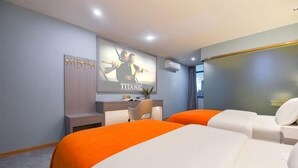 A hotel room with two beds, a desk, a mirror, and a poster on the wall. - Haixing Business Hotel (Zhongshan)