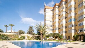 A modern apartment building with a swimming pool, surrounded by palm trees and greenery. - Boutique Sea view studio 2A - La Cala de Mijas (La Cala de Mijas)