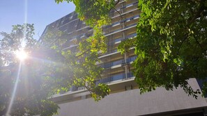 A multi-story building with balconies, surrounded by trees. - Wellspring by Silks Beitou (Taipei)