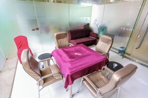 Enjoy a view of the outside from this room, featuring a table and six chairs, a sofa, and a small table with a bowl.