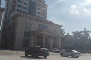 A building with a prominent entrance and a sign above it. - Xinghe Hotel(Dongguan Humen road east) (Dongguan)