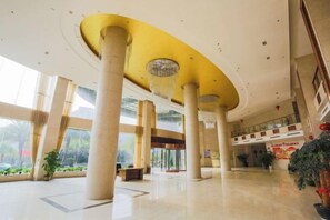 A spacious lobby with high ceilings, large columns, and a central chandelier. - Shan Shui Xiang Ge Li La Hotel (Dingnan)
