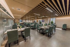 A spacious dining area with multiple tables and chairs, a modern ceiling design, and a clean, well-lit environment. - Antai Century Hotel (Chengdu)