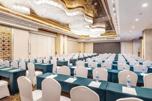 A conference room with rows of tables and chairs, equipped with water bottles and name cards. - Antai Century Hotel (Chengdu)