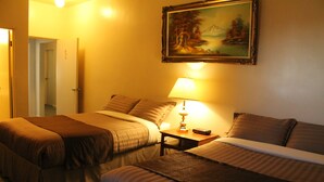 A hotel room with two beds, a painting on the wall, and a lamp on the nightstand. - Outlook Motor Hotel (Outlook)