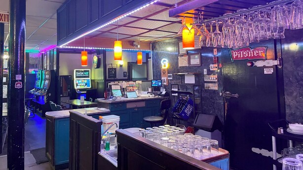 A bar area with a counter, multiple glasses, and a sign for 'Pilsner' beer. - Outlook Motor Hotel (Outlook)