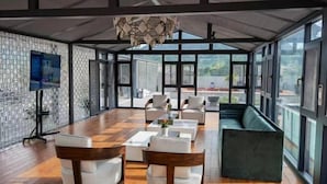 A spacious room with a long table, several chairs, and a sofa. - Shexiang Hongbin Hotel (Jingning)