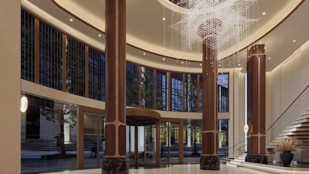 A spacious lobby with high ceilings, large windows, and a modern chandelier. - Shexiang Hongbin Hotel (Jingning)