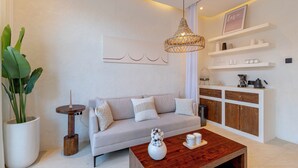 A modern living room with a sofa, coffee table, and decorative items. - OriVista Luxe 1BR Designer Pool Villa in Canggu (Canggu)