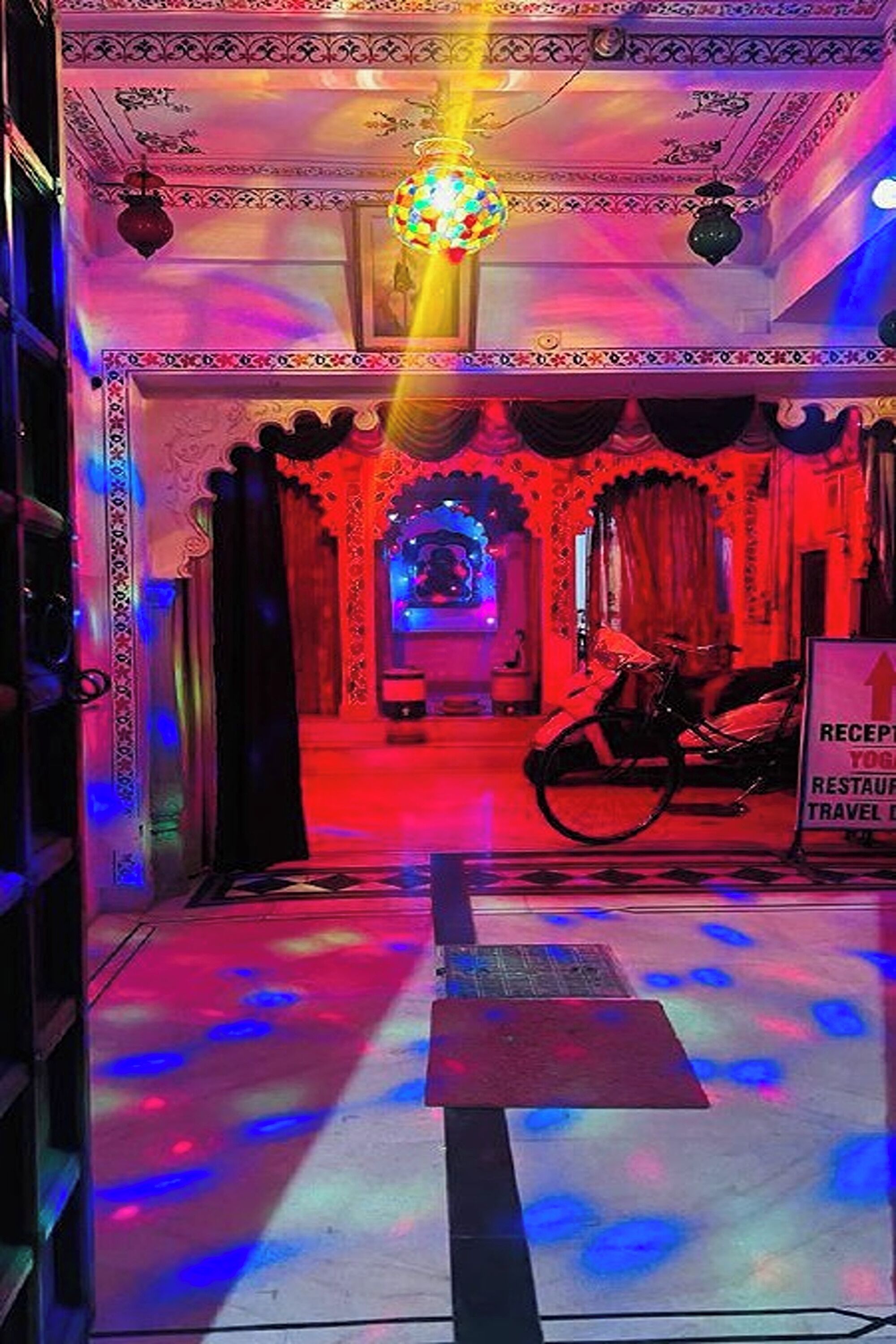 A reception area with a sign indicating a yoga restaurant and travel agency.
