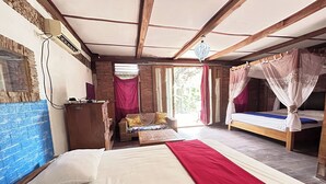A room with a bed, a sofa, and a window with curtains. - Chez Laelik (Sewon)