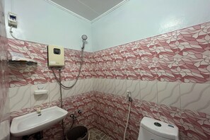 A bathroom with a sink, toilet, and shower. - FNT Transient House near Hundred Islands (Alaminos)