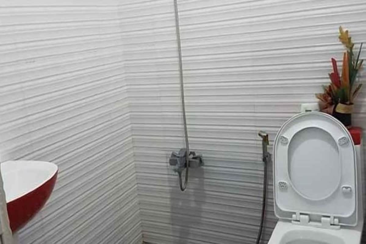 A bathroom with a shower, toilet, and sink.