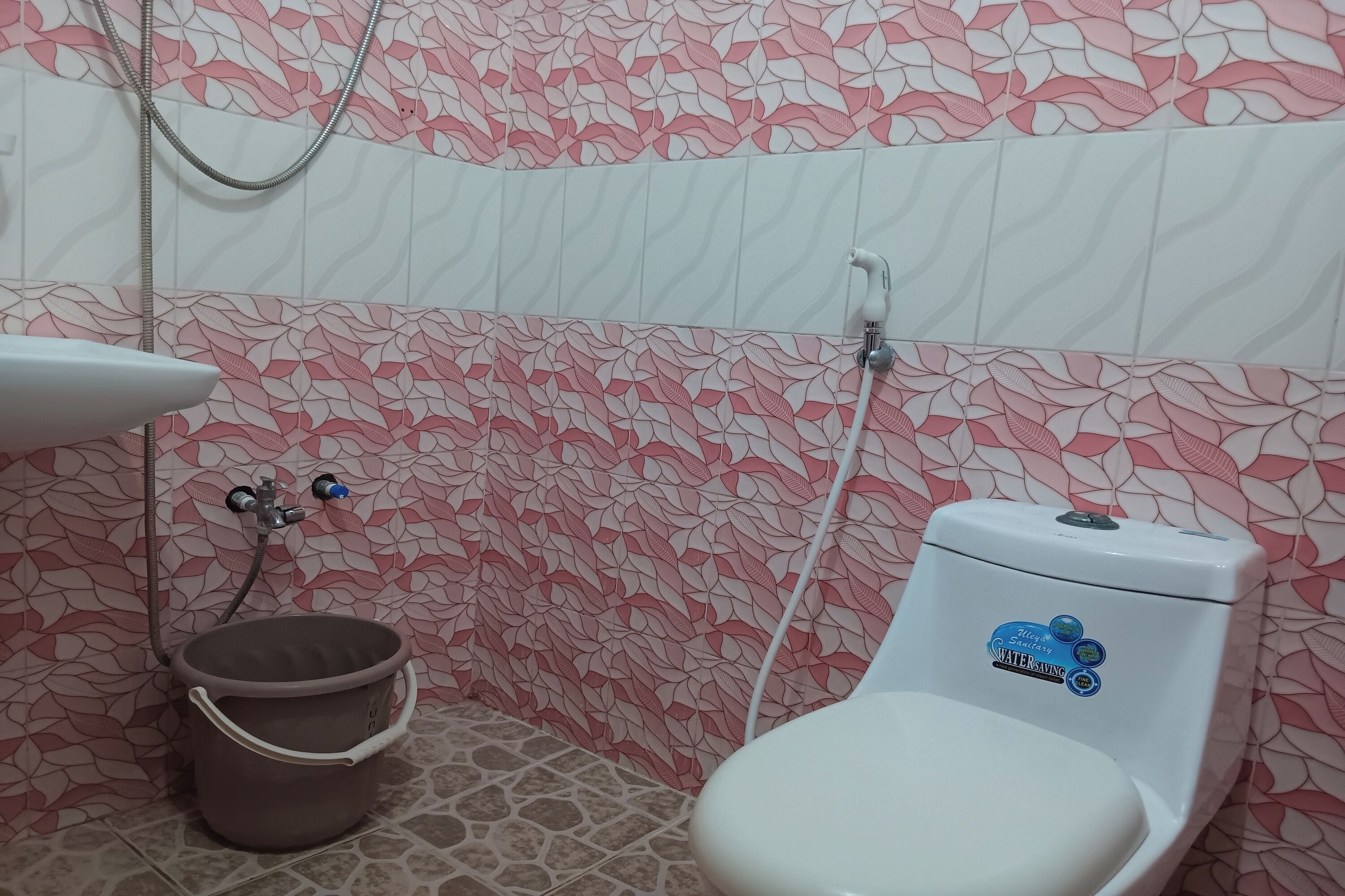 A bathroom with a toilet, a sink, and a shower.