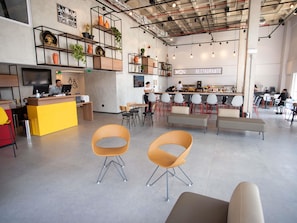 A modern restaurant interior with a bar area, seating, and a counter. - Ibis Serra Talhada (Serra Talhada)