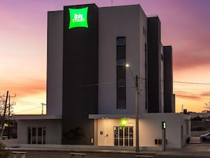 A modern building with a prominent green sign reading 'ibis Styles' on the facade. - Ibis Styles Barretos (Barretos)
