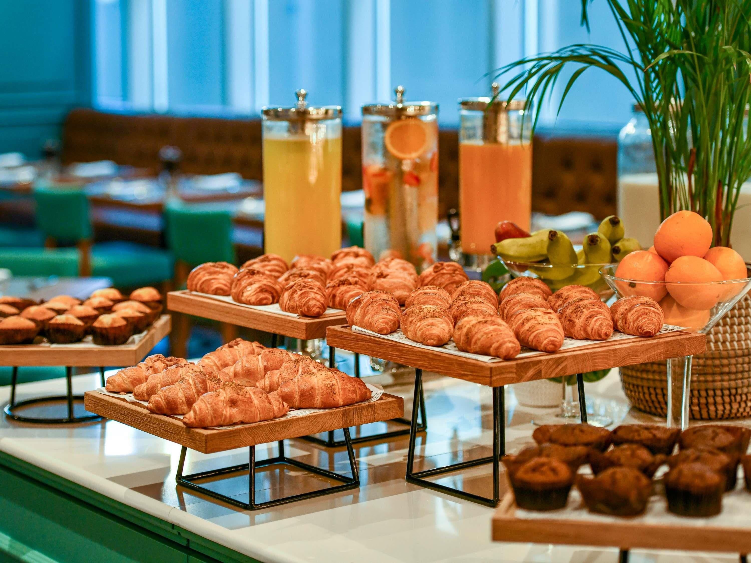 A buffet with various pastries and drinks.