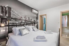 Relax in this stylish room with a large bed and convenient access to adjacent spaces.