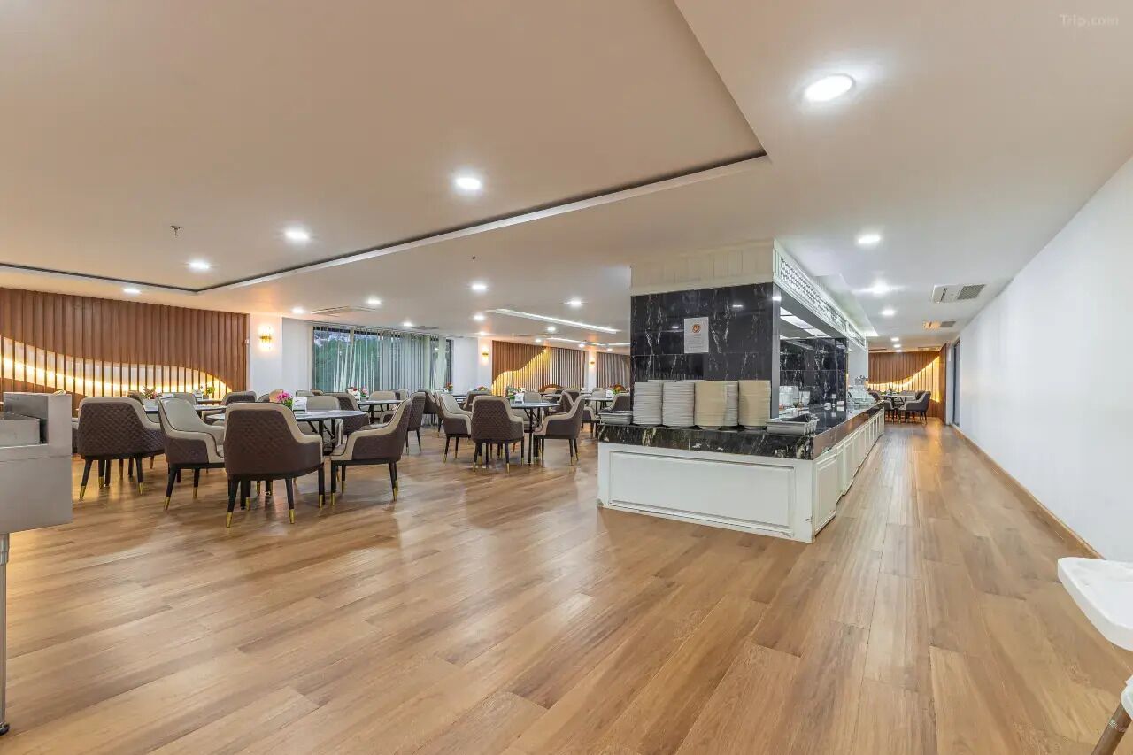A spacious dining area with wooden flooring and modern furniture.