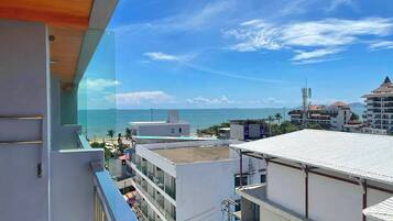 A high-rise building with a view of the ocean and other buildings.