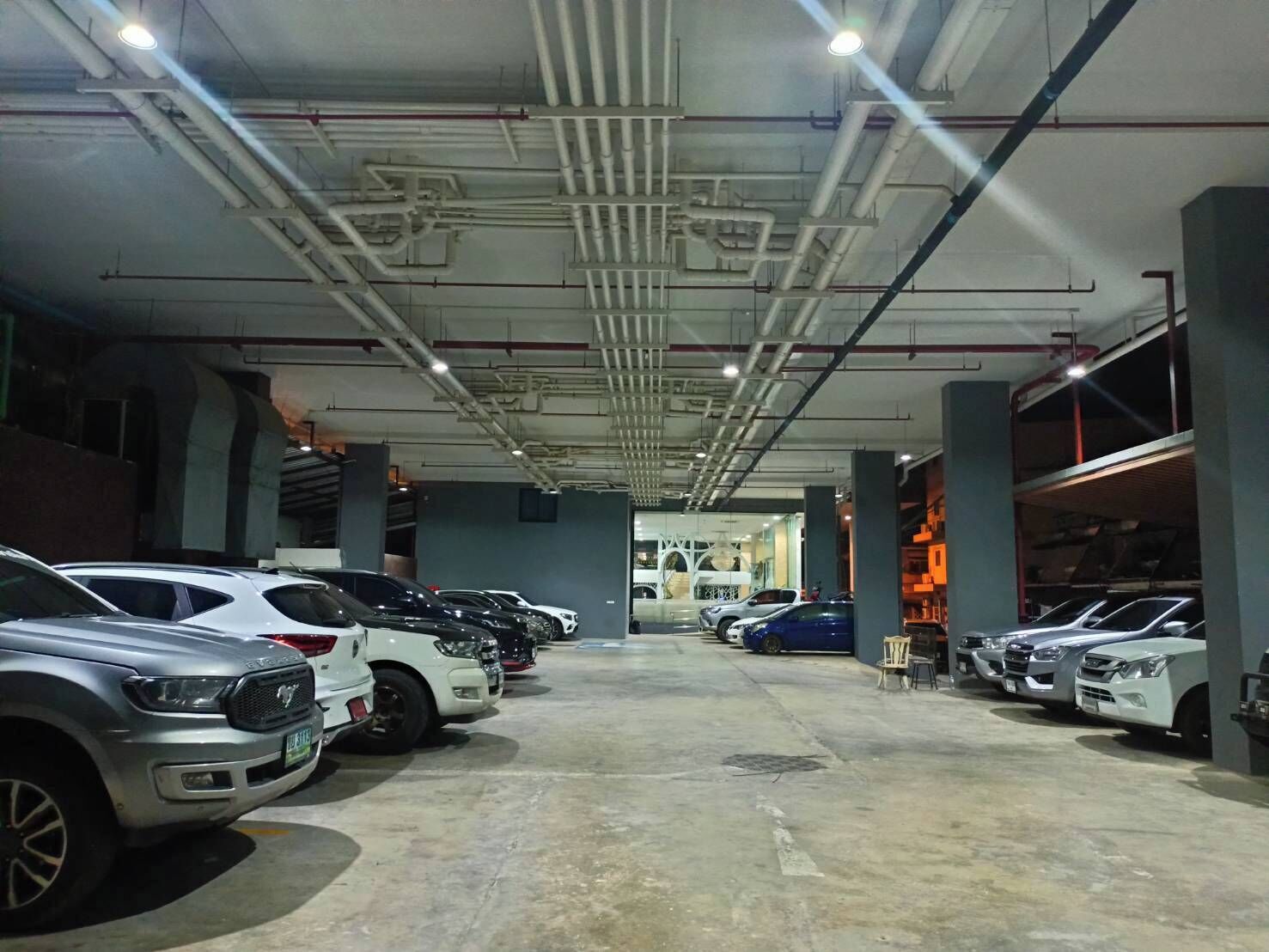 A multi-level parking garage with several cars parked on each level.