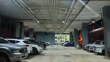 A multi-level parking garage with several cars parked on each level.