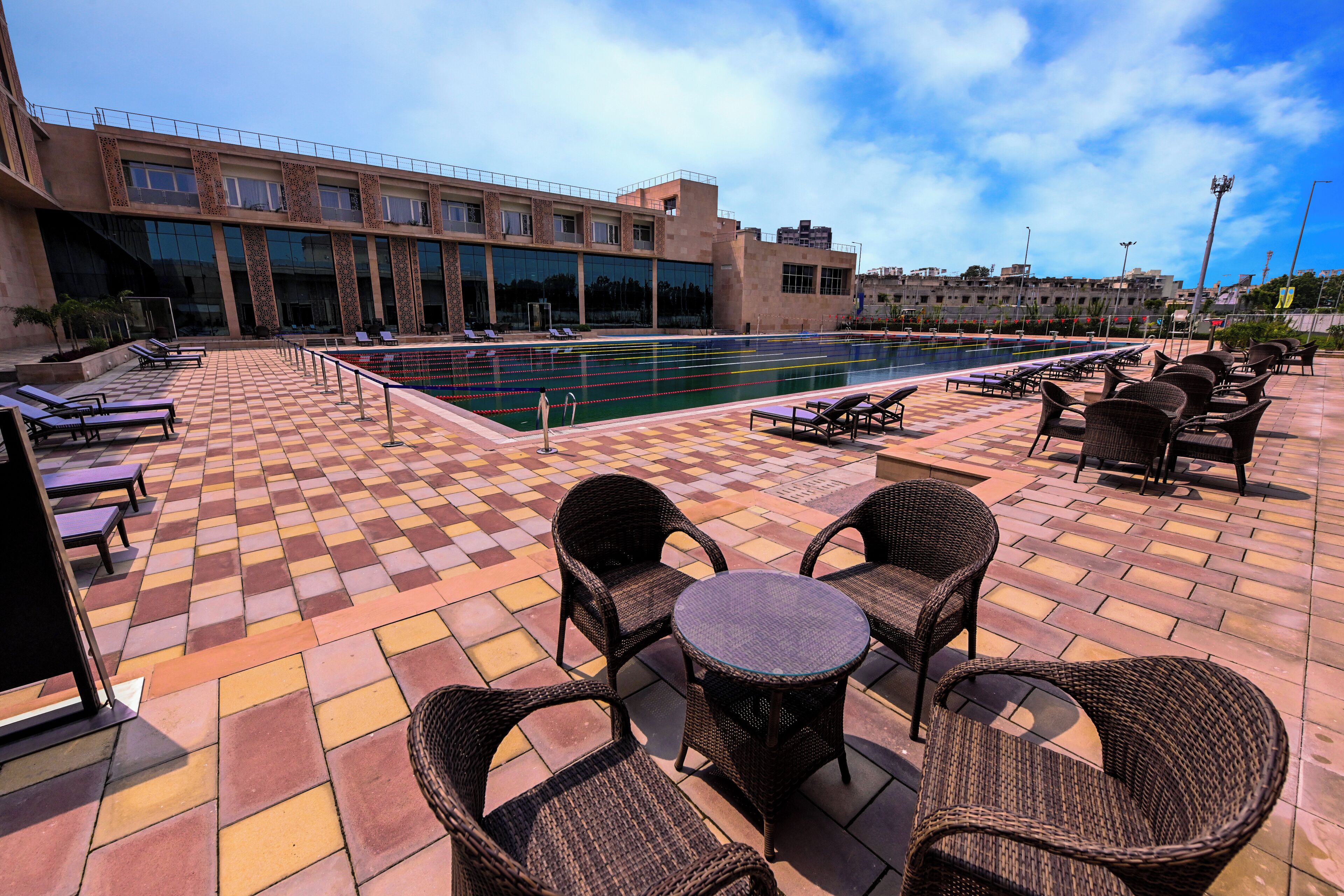 A poolside area with lounge chairs and a tiled deck.