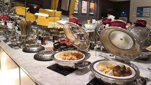 A buffet setup with various food items and utensils. - Jinjiang Inn (Shanghai People's Square East Huaihai Road) (Shanghai)