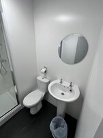 Chuveiro, sabonete, shampoo, papel higiênico