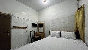 A bedroom with a bed, a chair, a desk, a television, and a wardrobe. - Hotel O Kost Aisyah Near Citra Grand Galesong City(Pattalassang) (Pattallassang)
