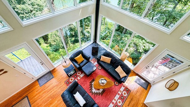 A spacious living area with a large window overlooking a lush garden.