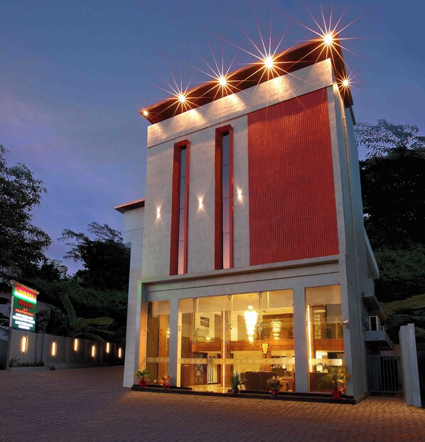 Stunning hotel facade with a symmetrical design and glass entrance.