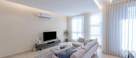 Luxury Apartment, 3 Bedrooms, Balcony, Garden View | Living area | Flat-screen TV