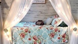 A bed with a floral bedspread, a small stool, and a wall-mounted sign. - 4105  Slopes & Spokes Perfect Location (Beech Mountain)