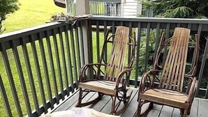 A wooden deck with two chairs and a table, surrounded by a black railing. - 4105  Slopes & Spokes Perfect Location (Beech Mountain)