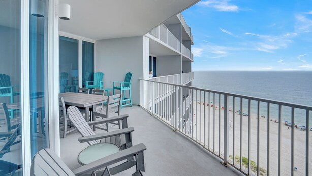 A balcony with a view of the beach, outdoor furniture, and a railing. - Lighthouse 1104 by Liquid Life (Gulf Shores)
