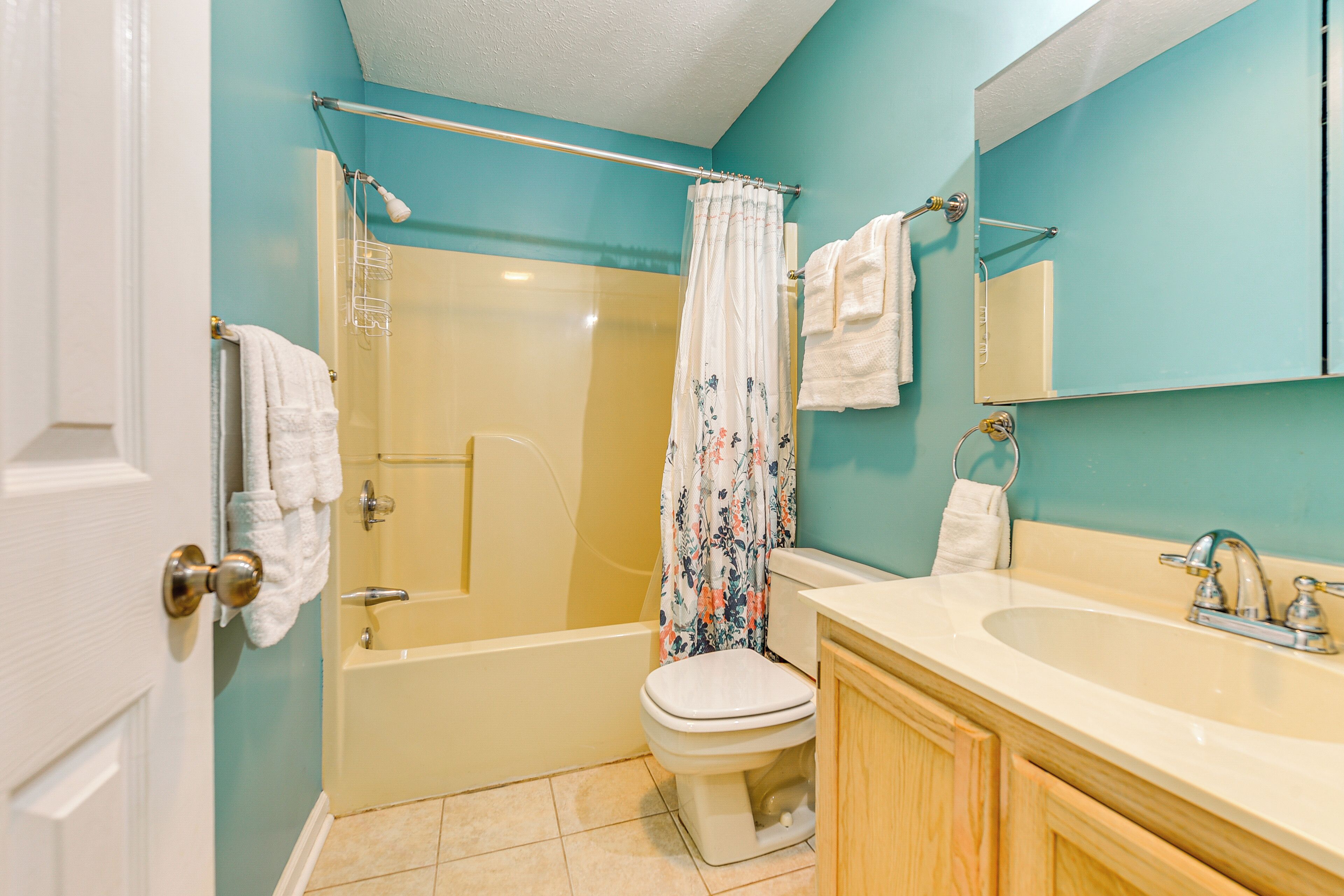 A bathroom with a bathtub, toilet, and sink.