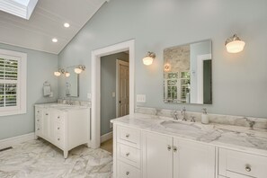 A bathroom with two sinks, white cabinetry, marble countertops, and wall-mounted lighting. - Spacious Taylors Home ~ 5 Mi to Dtwn Greenville! (Taylors)