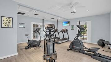 A home gym with treadmills, elliptical machines, and a stationary bike.