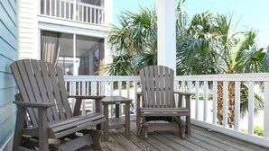 A wooden deck with two Adirondack chairs and a small table. - Walk to the Beach 5 BR Beach House with a Private Pool! I Choose You  (Surfside Beach)