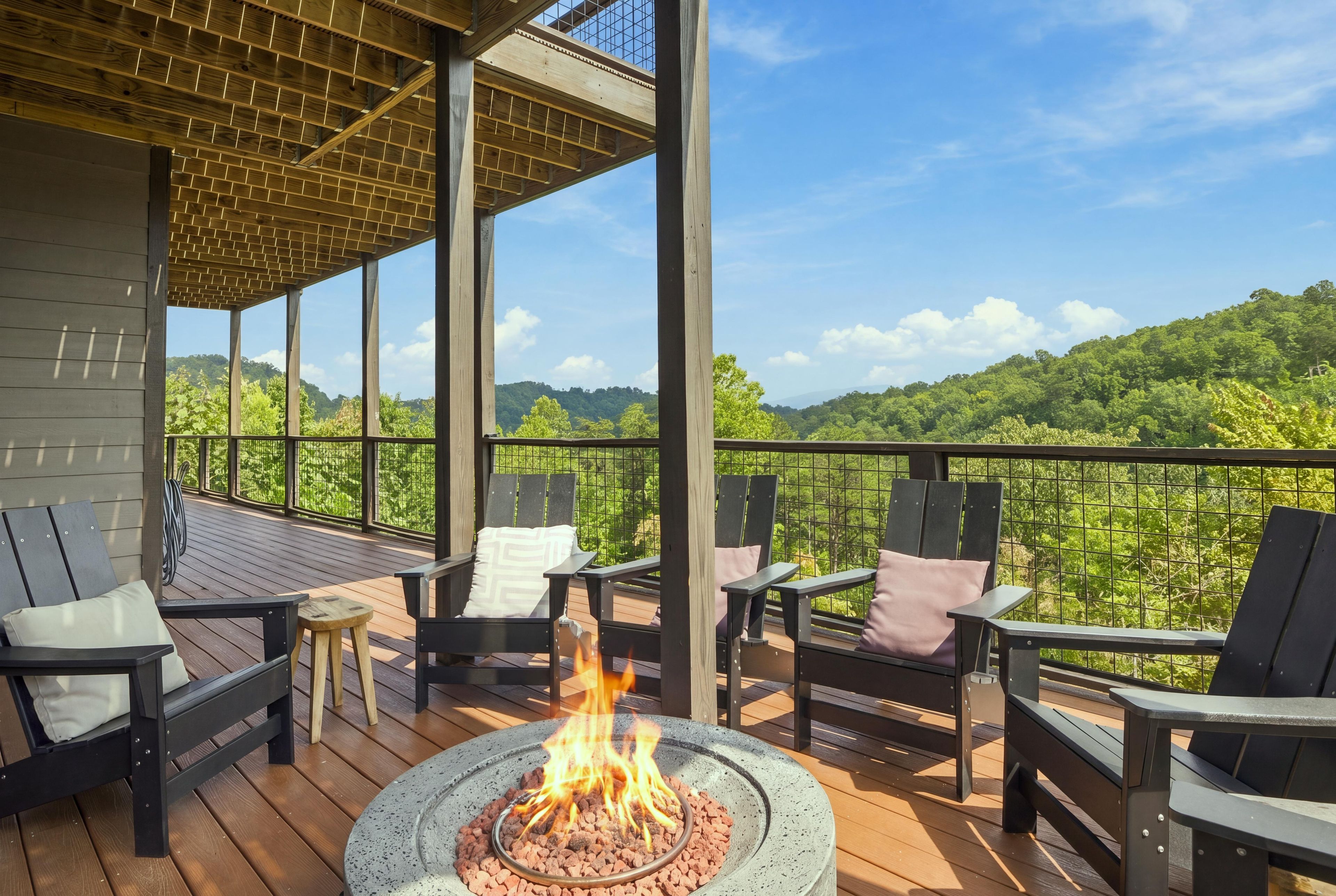 A deck with outdoor seating and a fire pit.