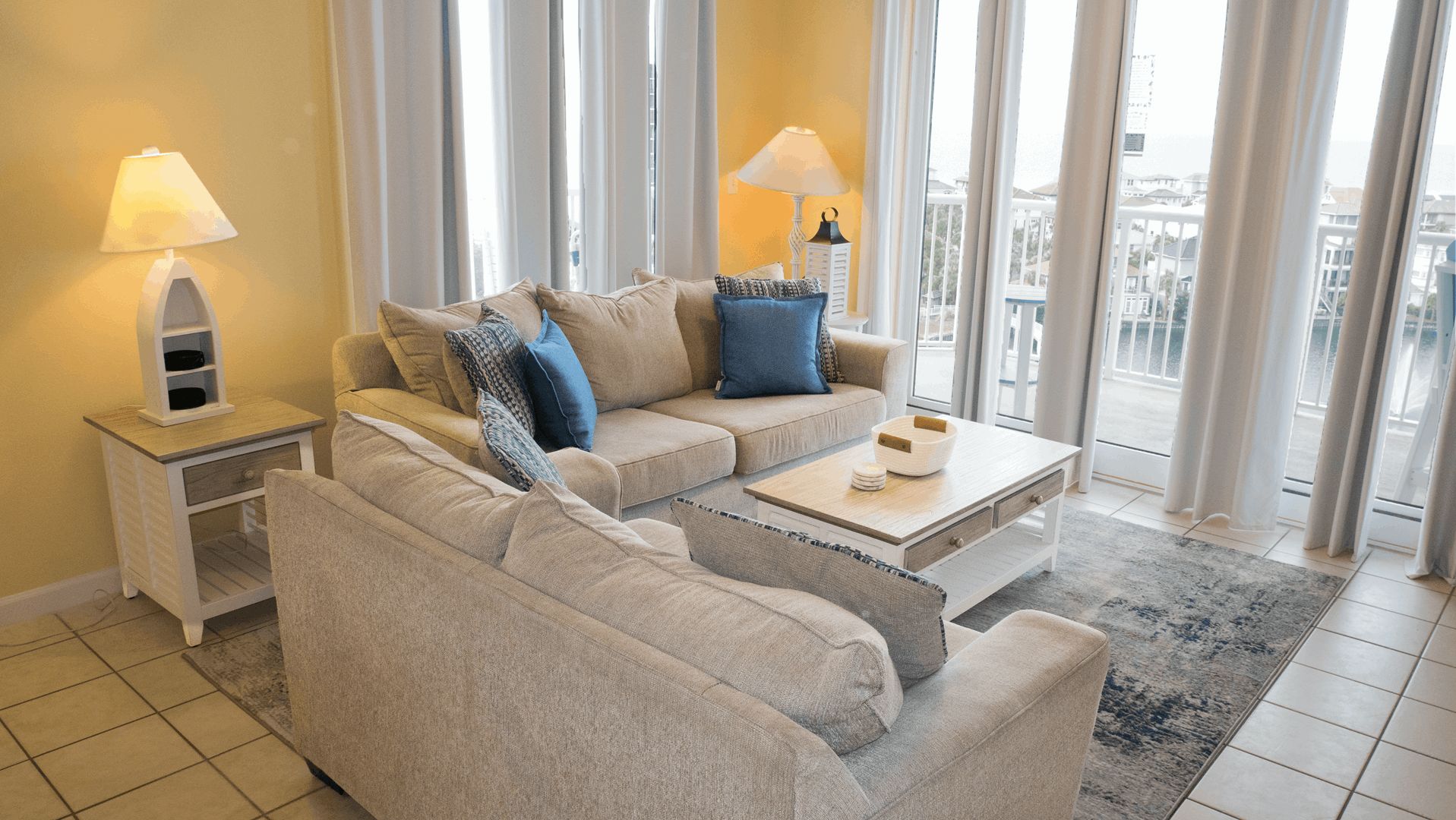 A modern living room with a sofa, coffee table, and lamps.